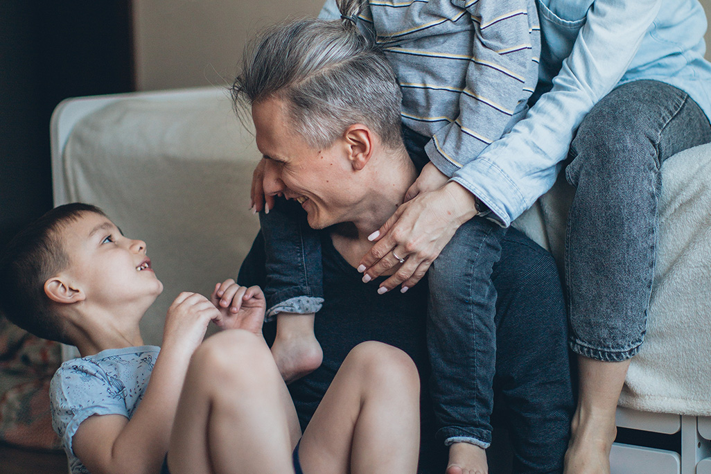 BIG TALK, image of dad and son with family laughing.